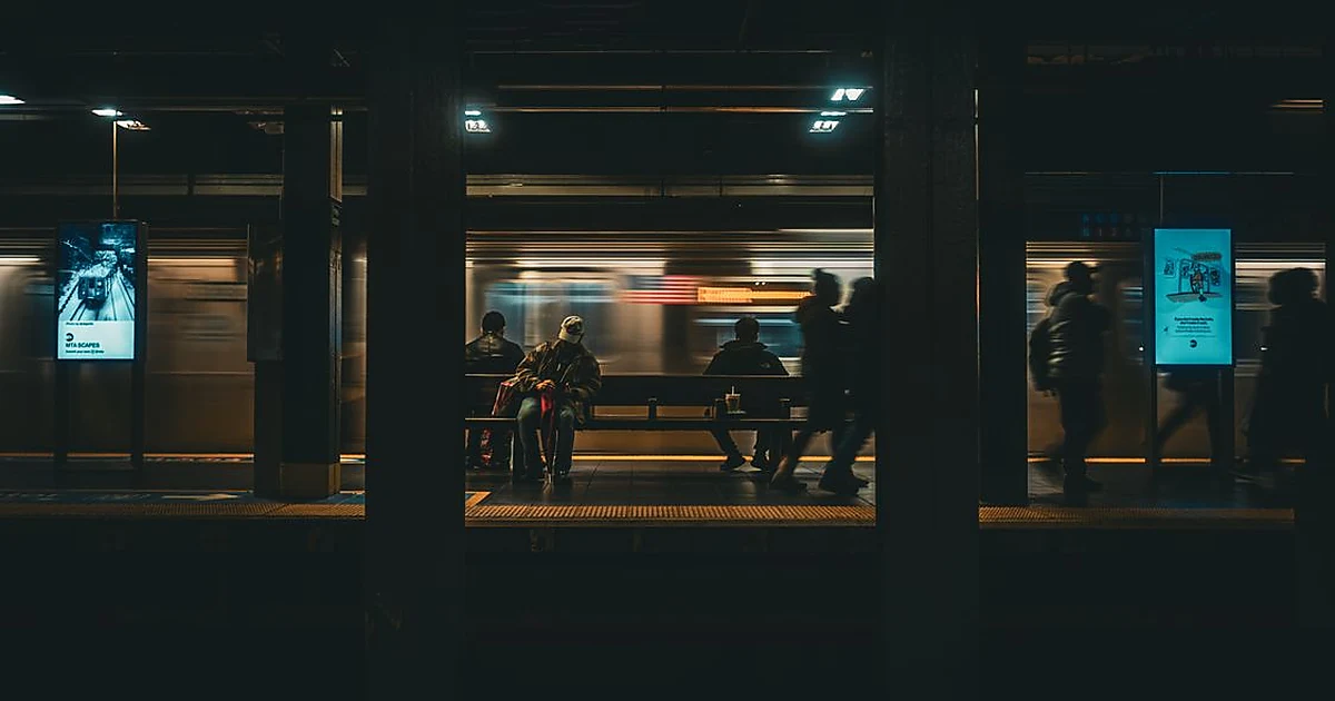 Subway transit station with train at night